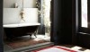 main_room_gallery_640_jenna-lyons-bath-olatz This is a wonderful space with black walls and crisp red accents as a diversion to the white tub with a painted black exterior. This is a sharp space.