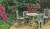 cast-stone table Grand scale and proportion feel right at home amongst large leaf rhododendrons.