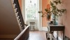 231 The elegant stairwell in a Charleston house rises three stories. The space has beautiful detail and a great color called Rhett Pumpkin that give the hall a warm glow that articulates the architectural elements.