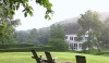 75 Beautiful outdoor rooms, sheltering trees and old Adirondack chairs create a sense of place.