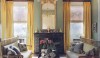 138 A traditional New Orleans interior in a Greek Revival house using a bold and strong color scheme. This is a traditional room with yellow silk curtains decorated with bright green bands and appropriately scaled Chinoiserie benches with charming vintage chintz patterns on the pillows.