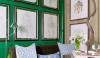 EmeraldOffice_HouseBeautiful An emerald green wall subdued with a brown velvet sofa is a great accent for a room. The red accents could make the space look like Christmas, but in skilled hands, it has charm and depth. (As seen in House Beautiful.)