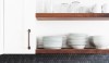 Remodelista Penny_Regan Baker Design A dark gray blend of penny round tiles makes an interesting backsplash.