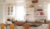 The open shelves of the galley kitchen open ip the space .  The 3 x 6 white ceramic backsplash tile have been installed with dark grout. That adds a bit of drama to the space.