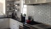 Dark Grout photo This handmade tile is installed with a sliver gray grout. The contrast is subtle and looks great with the dark counter and black stove.