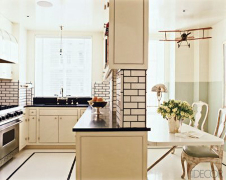 Elle Decor1 Dark grout on white tiles ties into the black counter top and border in the floor. This large grout joint and black grout adds a graphic element to this space.